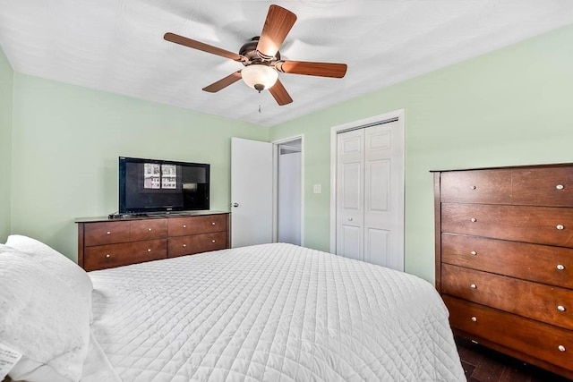 bedroom with a ceiling fan, a closet, and wood finished floors