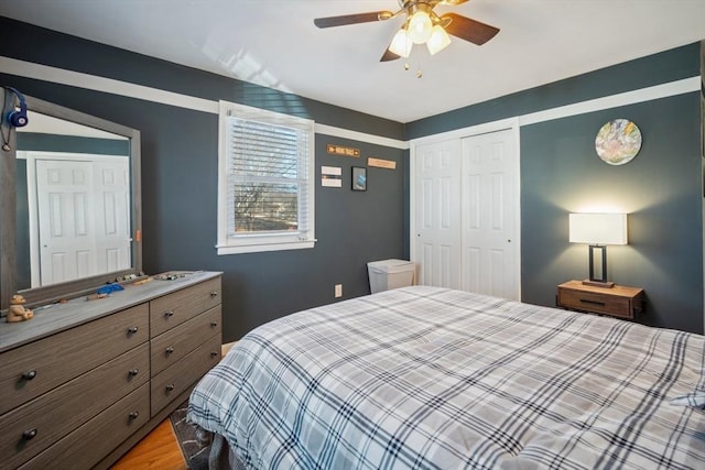 bedroom with a closet, ceiling fan, and light wood finished floors