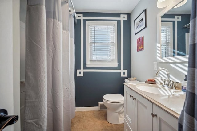 bathroom with toilet, a wealth of natural light, vanity, and visible vents