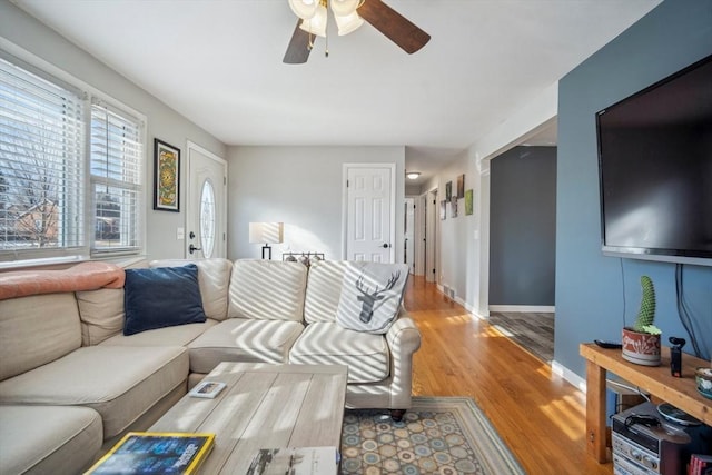 living room with ceiling fan, wood finished floors, and baseboards