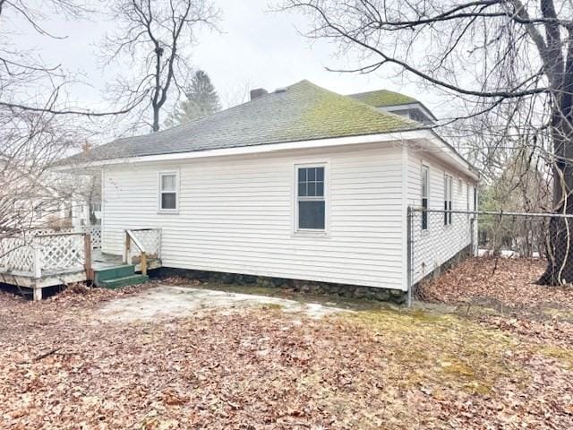 back of property with fence and a deck