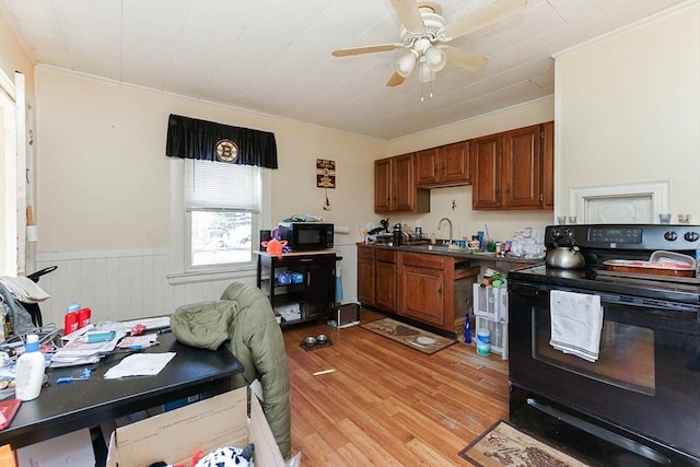 479 Main St, Hanson, MA 02341 - kitchen featuring black appliances, ornamental molding, a ceiling fan, brown cabinetry, and wainscoting