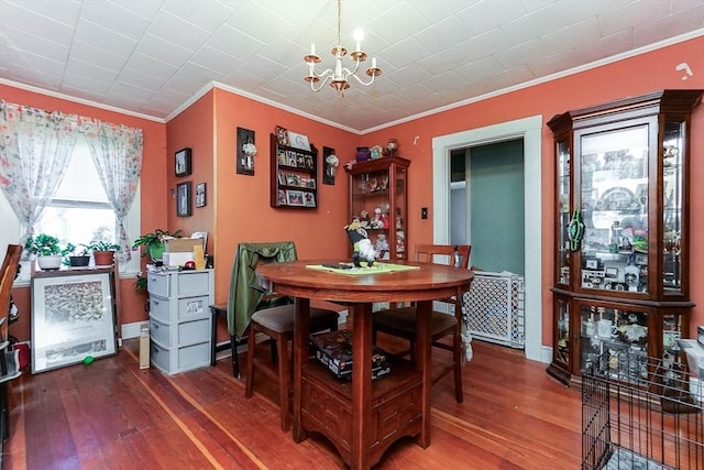 479 Main St, Hanson, MA 02341 - dining room with crown molding, a chandelier, hardwood / wood-style floors, and baseboards