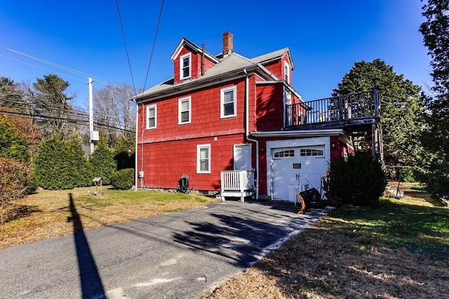 479 Main St, Hanson, MA 02341 - view of side of property featuring a chimney, a garage, driveway, and a yard
