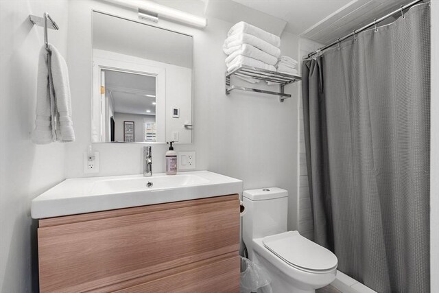 bathroom with a shower with curtain, vanity, and toilet