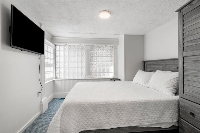 carpeted bedroom with a textured ceiling