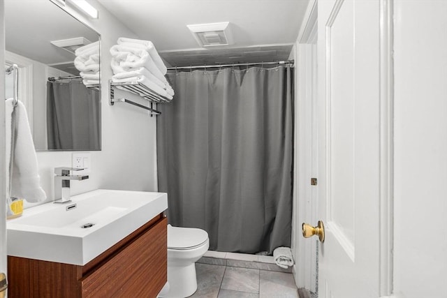 bathroom featuring vanity, a shower with shower curtain, tile patterned floors, and toilet