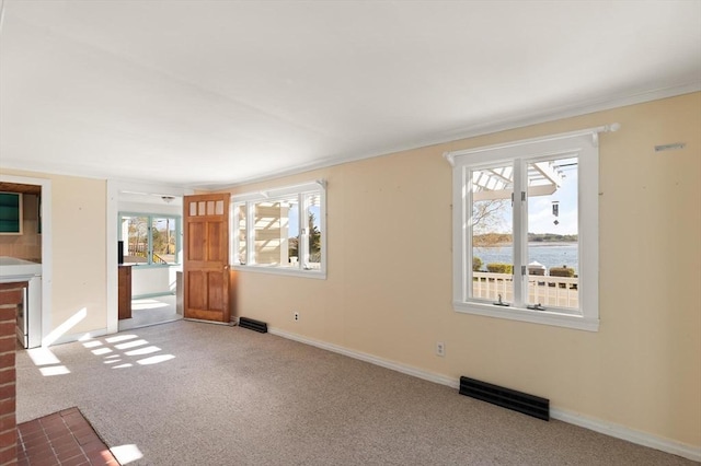 unfurnished living room with crown molding, carpet floors, and visible vents