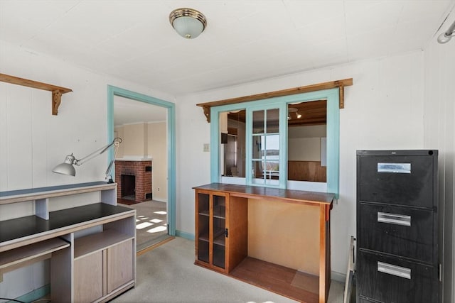 interior space featuring a brick fireplace and carpet