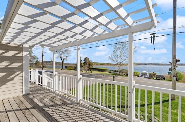 deck featuring a water view, a yard, and a pergola