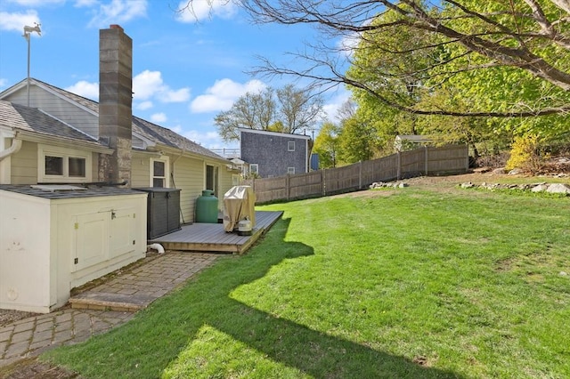 view of yard with fence and a deck