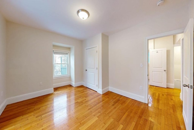 unfurnished bedroom featuring baseboards and light wood finished floors