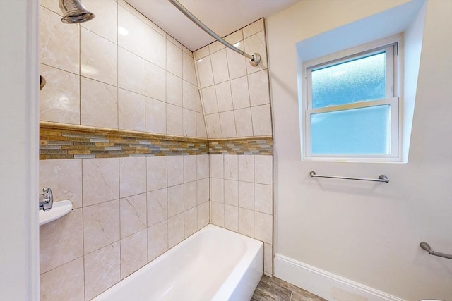 full bathroom featuring baseboards and tub / shower combination