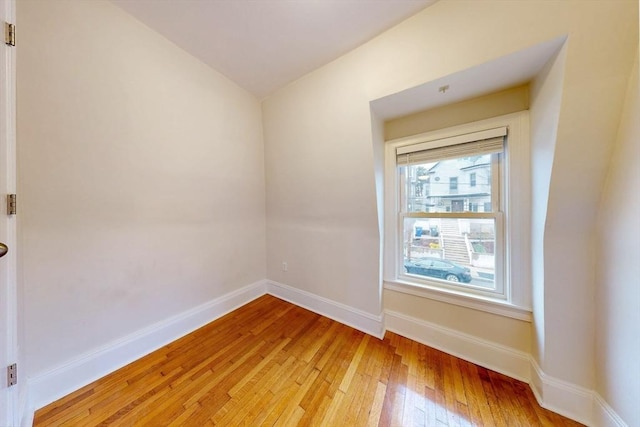 empty room featuring light wood-type flooring and baseboards
