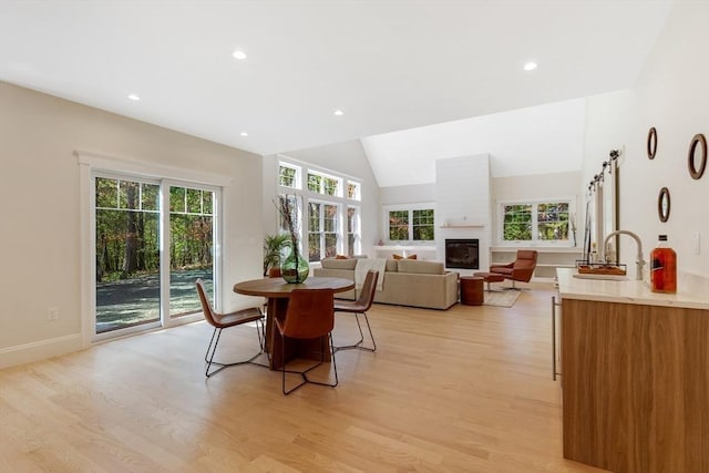 11 Cuba St, Andover, MA 01810 - dining area with light wood finished floors, a glass covered fireplace, recessed lighting, and vaulted ceiling