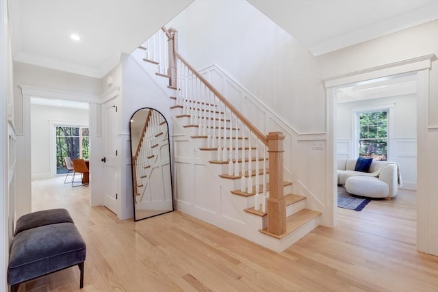 11 Cuba St, Andover, MA 01810 - stairway with a wealth of natural light, a decorative wall, a wainscoted wall, and wood finished floors