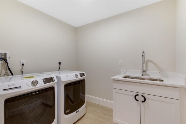 11 Cuba St, Andover, MA 01810 - laundry room with a sink, washer and clothes dryer, cabinet space, light wood-type flooring, and baseboards