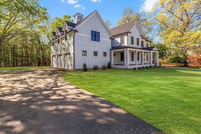 11 Cuba St, Andover, MA 01810 - rear view of house with covered porch, board and batten siding, a yard, and driveway