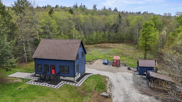 view of subject property featuring a heavily wooded area