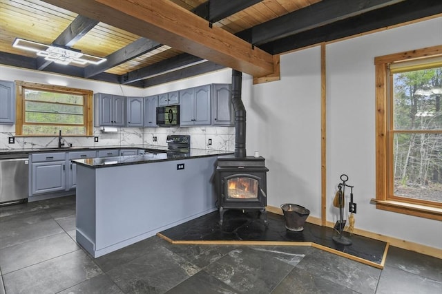 kitchen featuring black appliances, wooden ceiling, dark countertops, beamed ceiling, and a peninsula