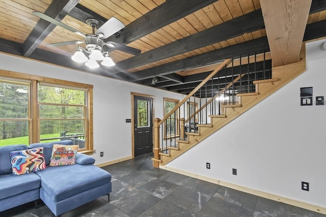 living area with baseboards, wooden ceiling, beam ceiling, stairs, and a ceiling fan