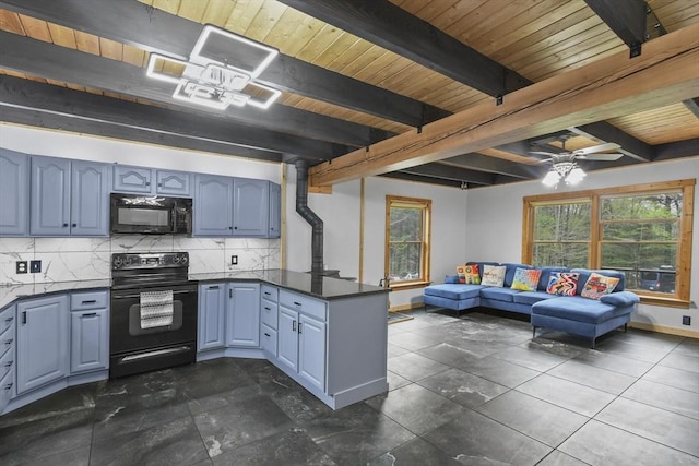 kitchen with black appliances, dark countertops, a peninsula, plenty of natural light, and beam ceiling