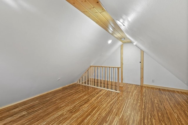 bonus room featuring vaulted ceiling and wood finished floors