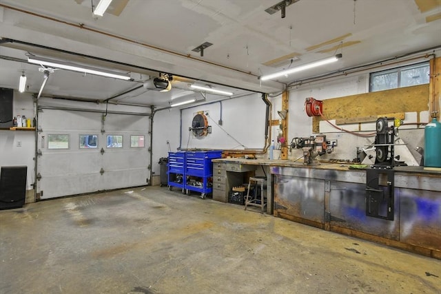 garage with a workshop area and a garage door opener