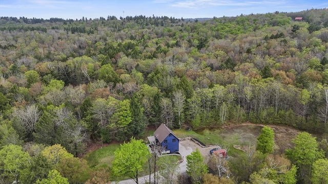 aerial view of property's location with a heavily wooded area