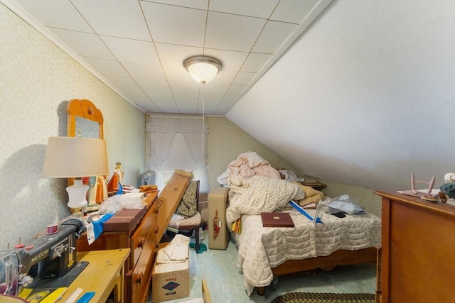 bedroom with wallpapered walls, lofted ceiling, and crown molding