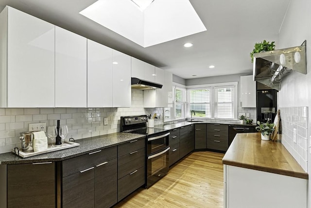 19 Mill Rd, Westborough, MA 01581 - kitchen with double oven range, modern cabinets, light wood-style flooring, under cabinet range hood, and recessed lighting