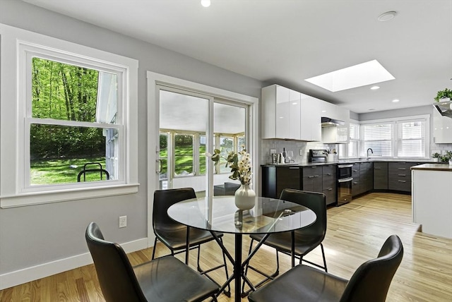 19 Mill Rd, Westborough, MA 01581 - dining area featuring a skylight, baseboards, light wood-style floors, and recessed lighting