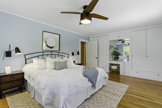 19 Mill Rd, Westborough, MA 01581 - bedroom with crown molding, light wood-style flooring, multiple closets, and a ceiling fan