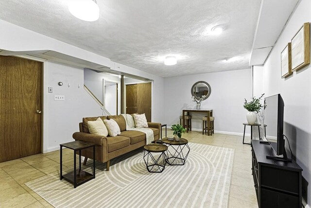 19 Mill Rd, Westborough, MA 01581 - living area featuring light tile patterned floors, a textured ceiling, baseboards, and stairway