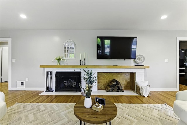 19 Mill Rd, Westborough, MA 01581 - living area with a brick fireplace, baseboards, recessed lighting, and wood finished floors