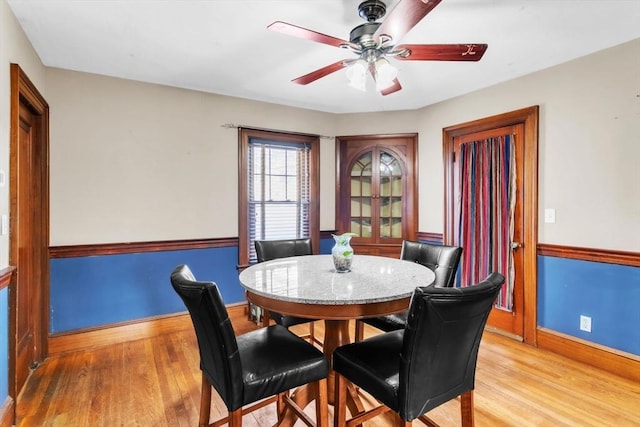 dining space with ceiling fan and light hardwood / wood-style floors