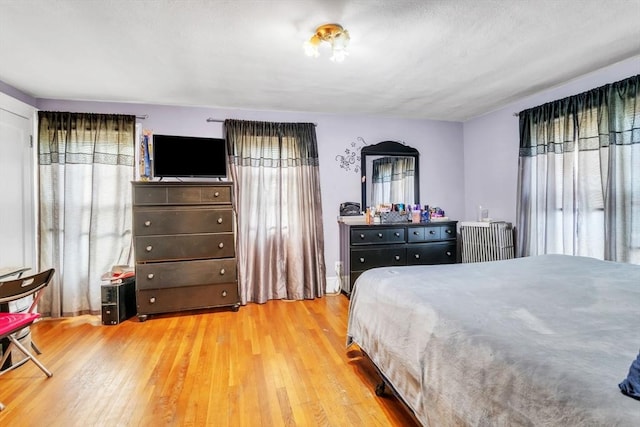 bedroom with radiator and light wood-type flooring