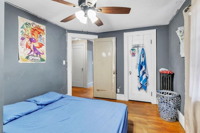 bedroom with ceiling fan and light hardwood / wood-style floors