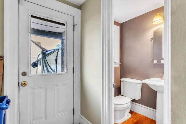 bathroom with toilet and hardwood / wood-style floors