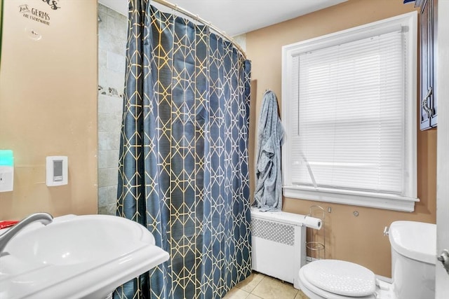 bathroom with toilet, walk in shower, tile patterned flooring, sink, and radiator heating unit