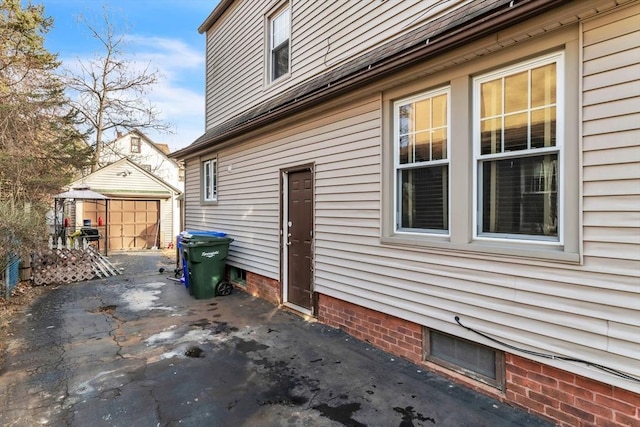 view of home's exterior with a garage and an outbuilding