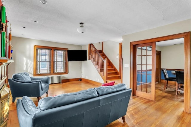 living room with hardwood / wood-style flooring and radiator