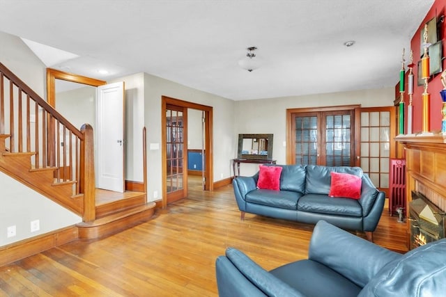 living room featuring light hardwood / wood-style flooring and french doors