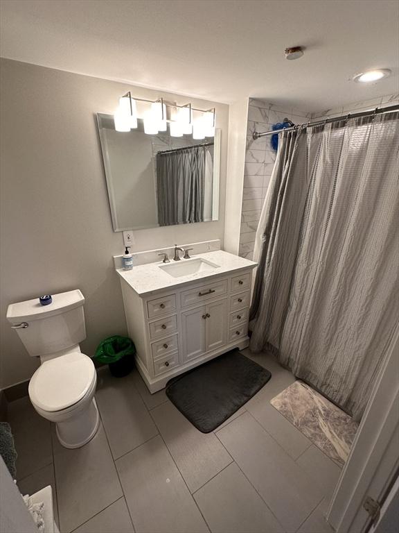 881 E 1st St Unit 303, Boston, MA 02127 - full bathroom featuring vanity, toilet, and a shower with curtain