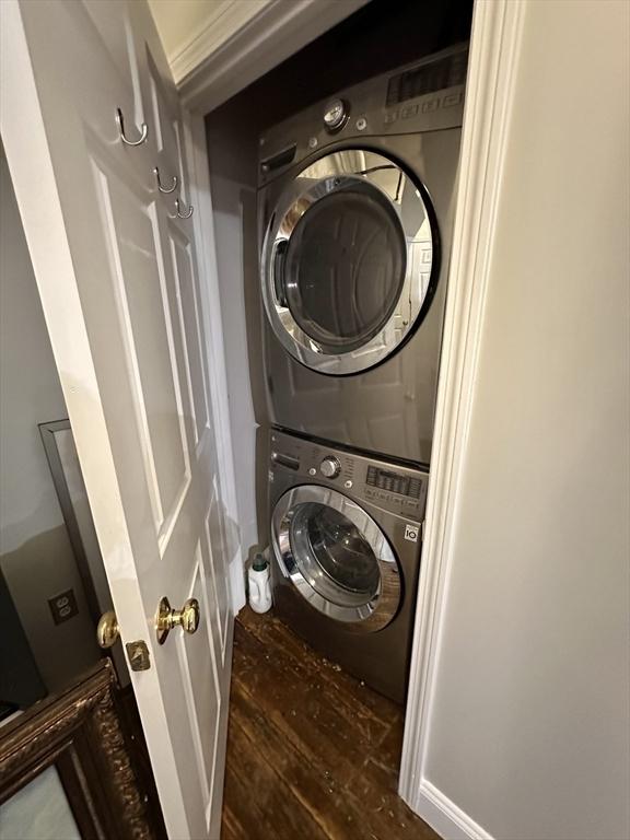 881 E 1st St Unit 303, Boston, MA 02127 - laundry room featuring stacked washer and clothes dryer and wood finished floors