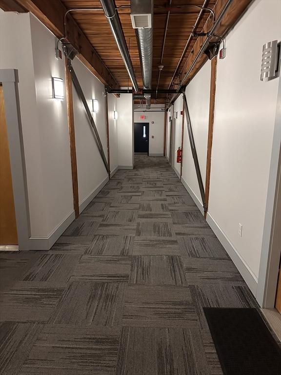 881 E 1st St Unit 303, Boston, MA 02127 - hall with carpet flooring, a barn door, and baseboards