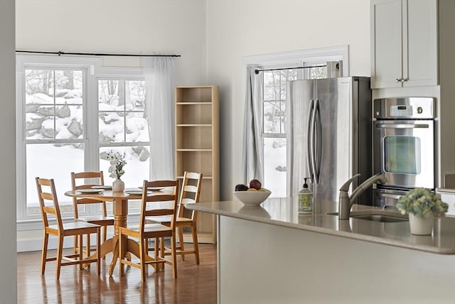 kitchen featuring sink, dark wood-type flooring, white cabinetry, and appliances with stainless steel finishes