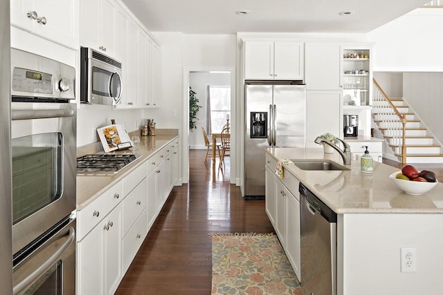 kitchen featuring sink, dark wood-type flooring, white cabinetry, light stone counters, and stainless steel appliances