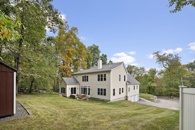 rear view of house with a yard