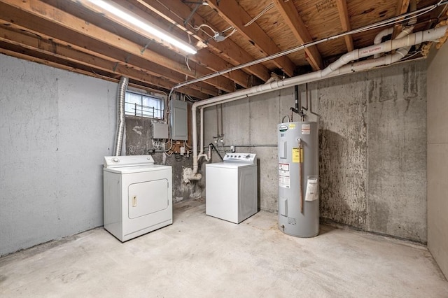 below grade area with electric panel, separate washer and dryer, and water heater